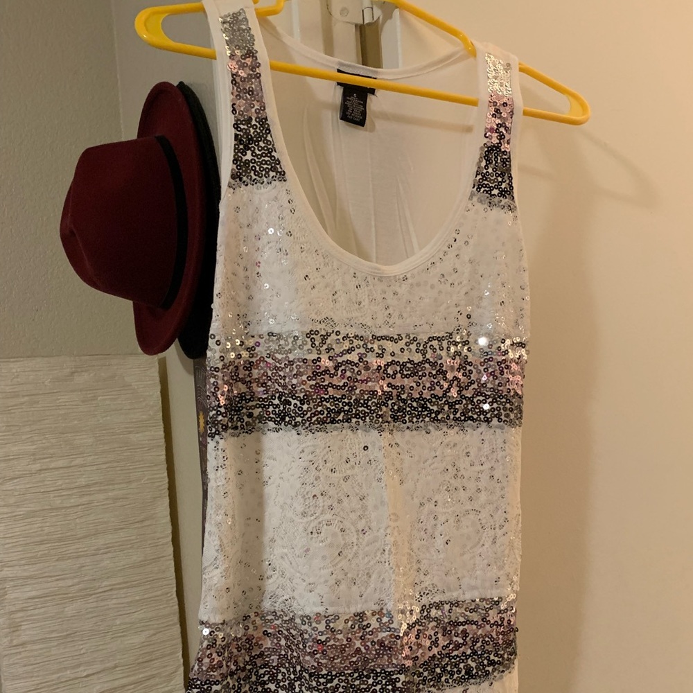 Sequin tank top, plain white on the back. Goes past my hips, little longer.